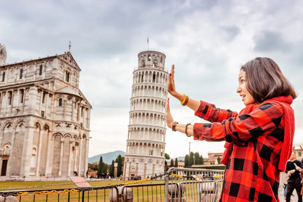 Woman pretending to hold up the Leaning Tower of Pisa