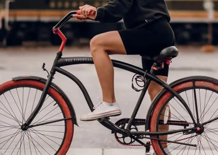 Woman riding a bike wearing Aspen Reprise biker shorts