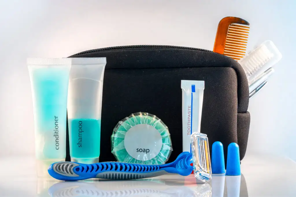 Toiletry bag with toiletries displayed in foreground