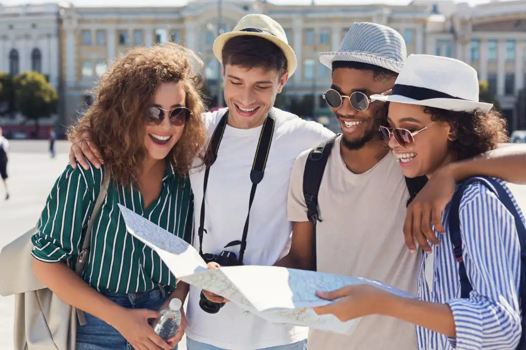 Group of friends looking at a map in the middle of a city