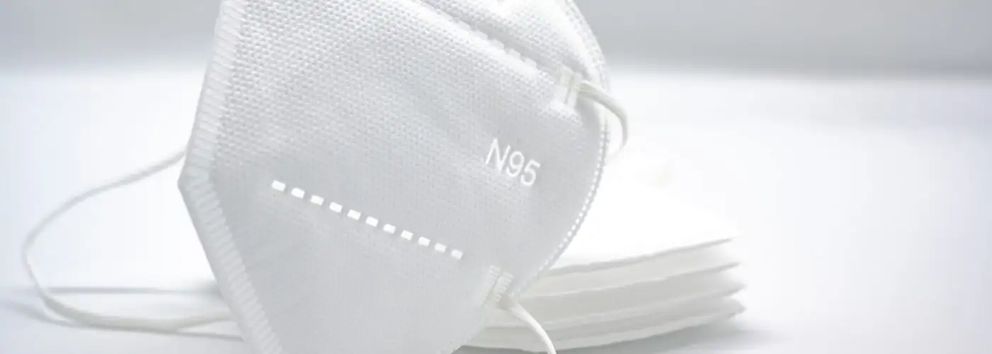 Stack of white N95 masks on a white background