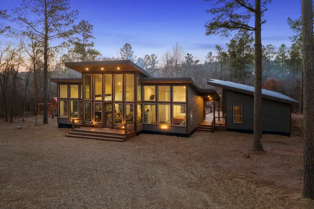 Modern house with large glass windows in the woods