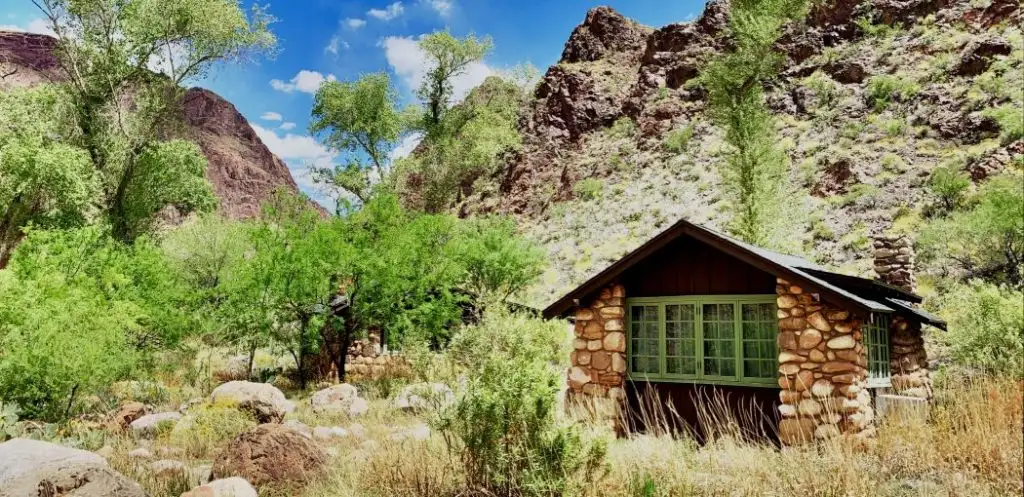 Small cabin surrounded by trees at the base of the Grand Canyon