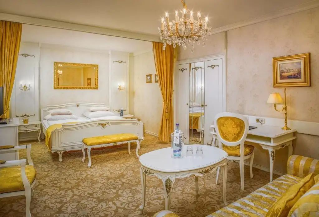Yellow and gold bedroom at Schlosshotel Römischer Kaiser in Vienna, Austria