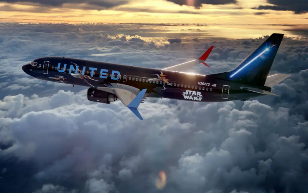 The Rise of Skywalker jet from United Airlines flying through clouds at sunset