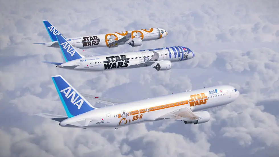 Three ANA Star Wars Project jets flying in a cloudy sky