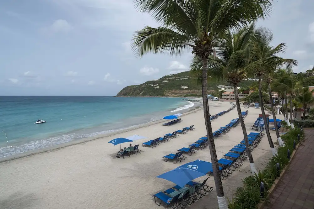 Beach lined with blue lounge chairs at Divi Little Bay Beach Resort, Philipsburg, Sint Maarten