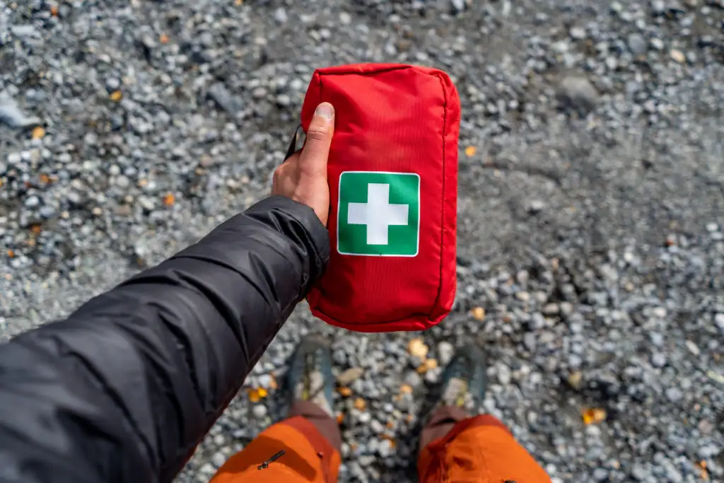 Top down view of a person holding a small travel first-aid kit