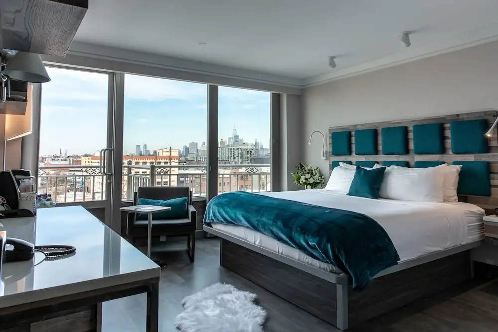 Bedroom overlooking the city skyline at Hotel Le Bleu in New York City