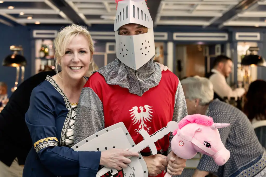 Crew members of the Mystery Cruise dressed as a knight and a queen to give guests a hint at their next destination