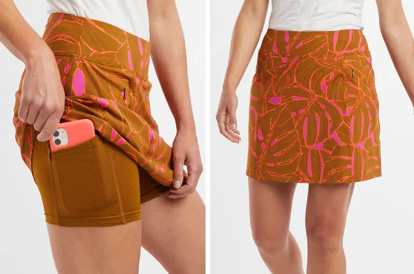 Two views of the Title Nine Majestic Skort in orange showing off the built-in shorts and pocket
