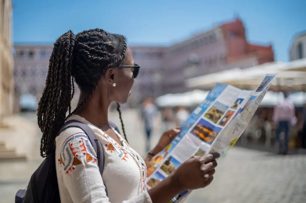 Woman studying a map in a square in Spain