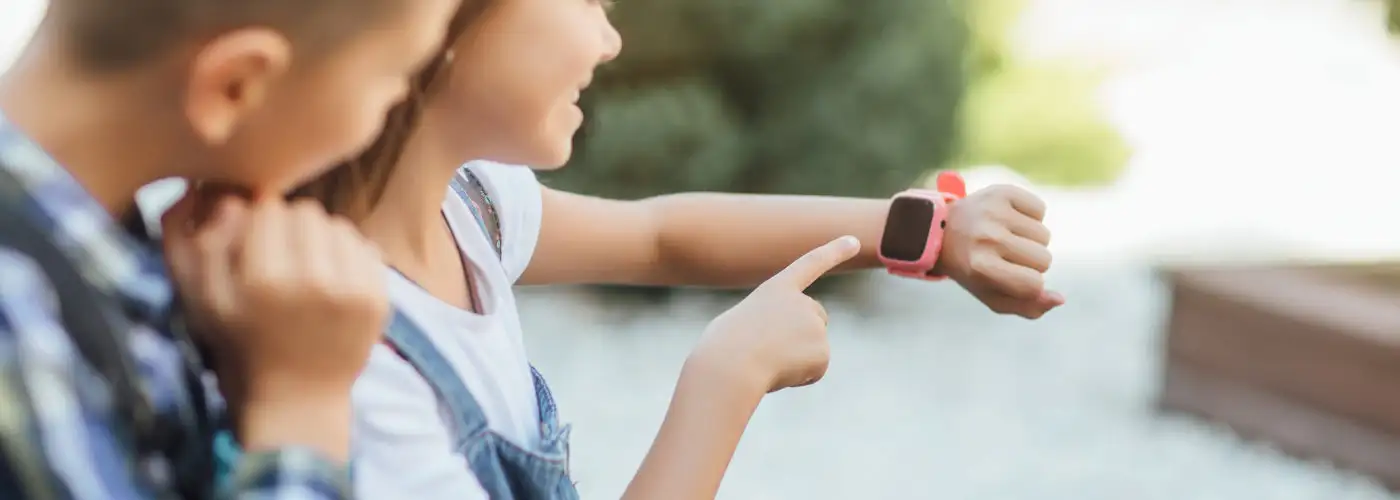 Two children looking at a smartwatch