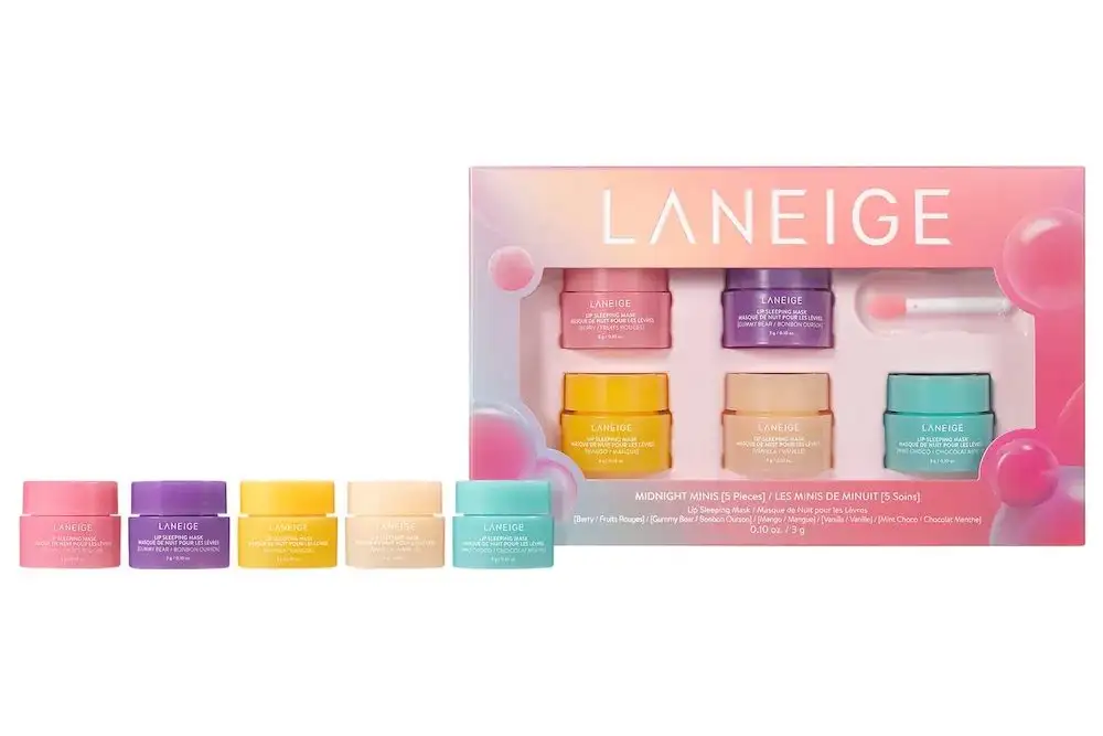 Different flavors of Laneige Midnight Minis Lip Sleeping Masks lined up next to a large box containing several Laneige Midnight Minis Lip Sleeping Masks