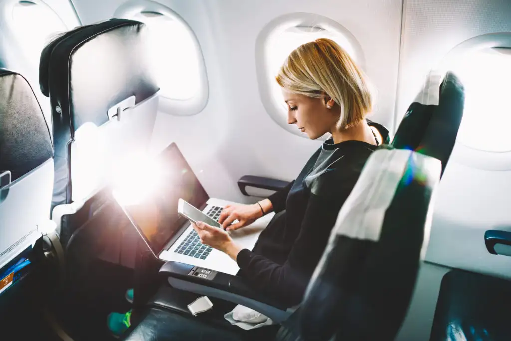 Woman on laptop on plane