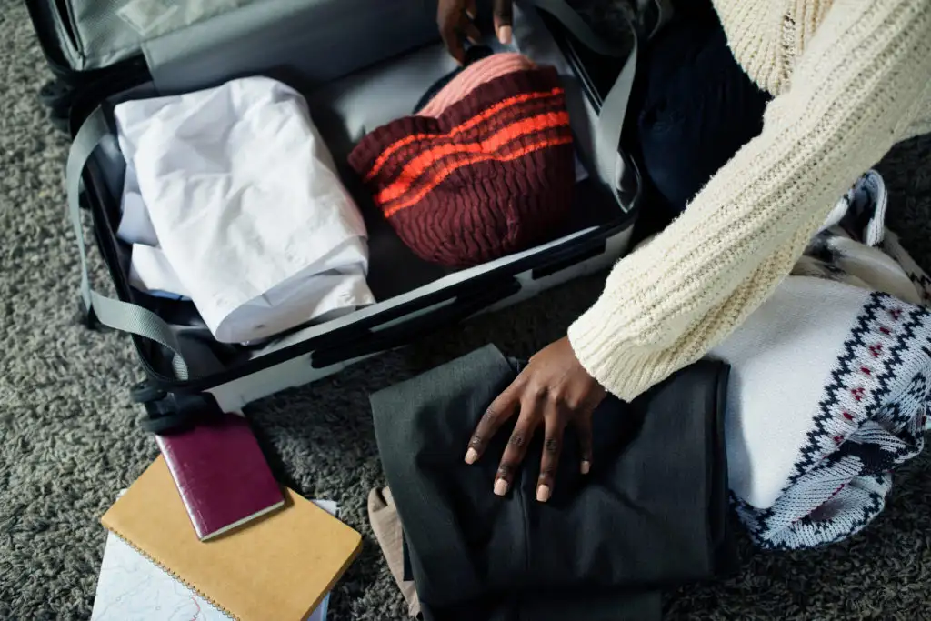 Close up of person's hands packing for trip