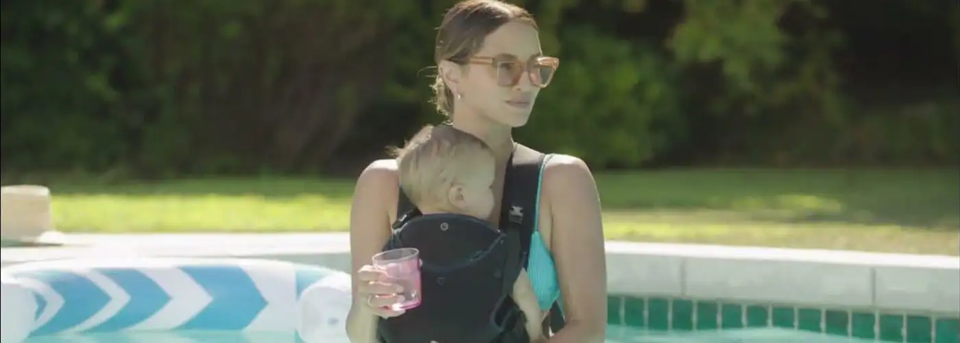 Mom carrying baby in pool in Aquaroo baby carrier