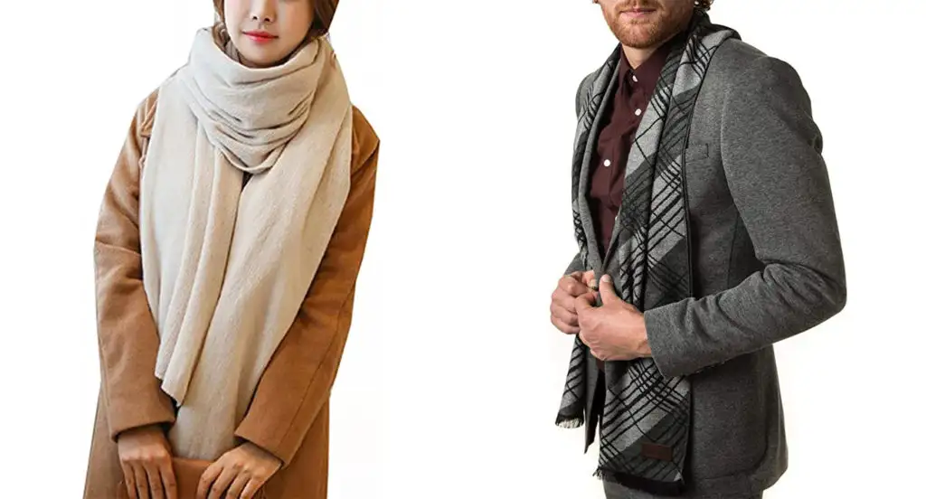 Woman wearing tan blanket scarf from Wander Agio (left) and man wearing a dark grey patterned scarf from Marino (right)