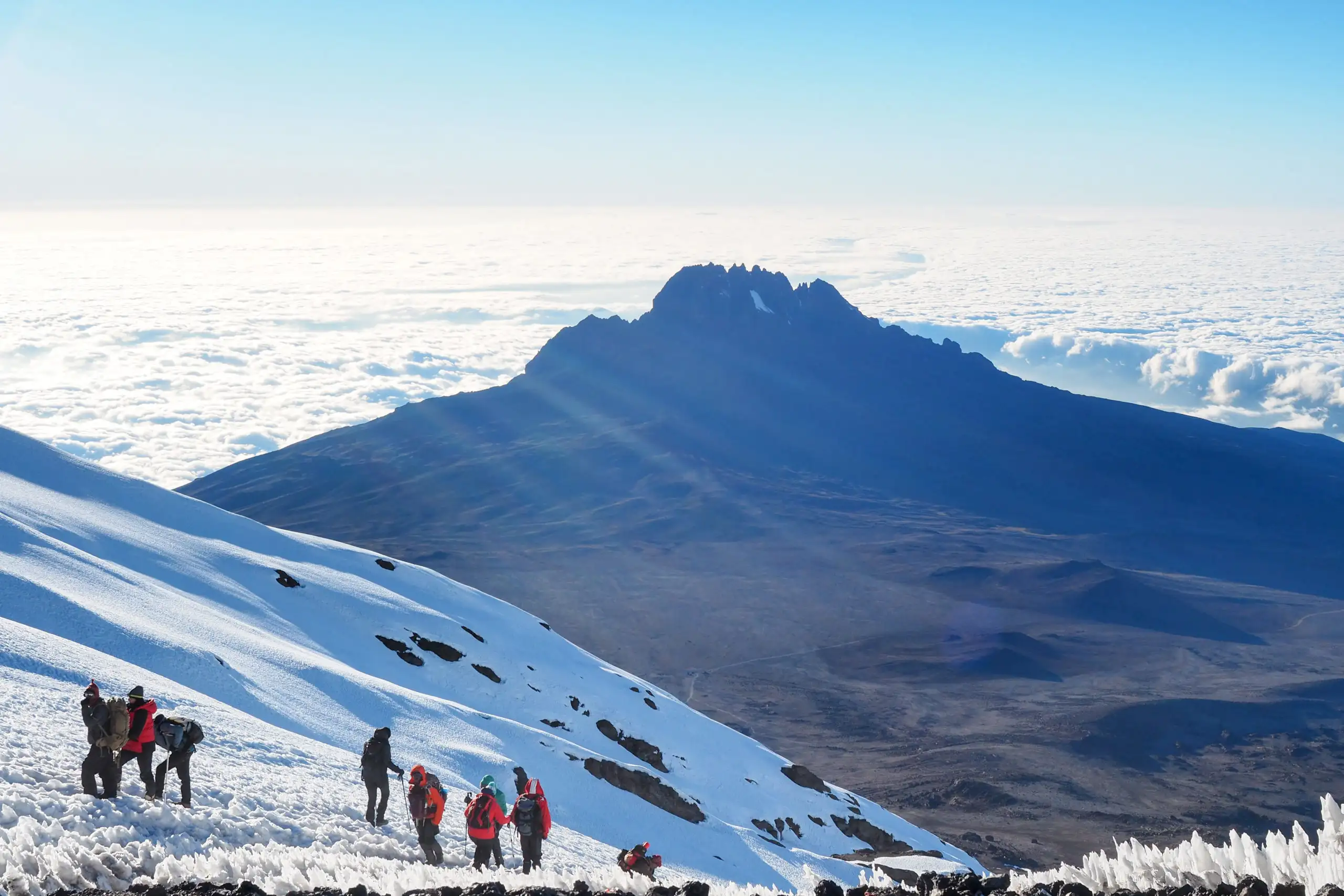 Group of people hiking through Mount Kilimanjaro in the snow