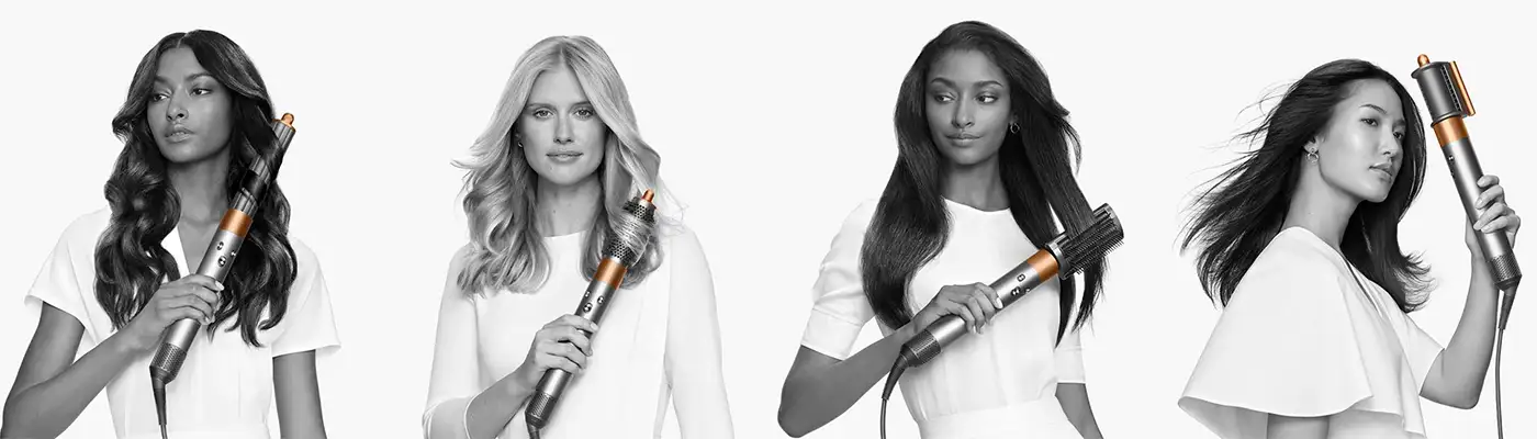 Four women using the Dyson Airwrap on their long hair, image in black and white