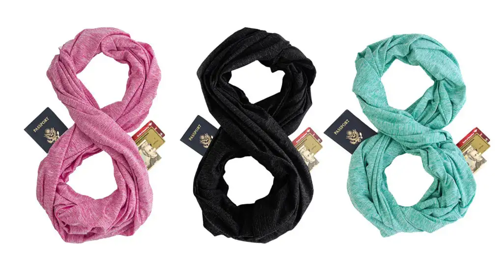 Zero Grid Infinity Scarf in pink, black, and teal with wallets, passports, and money hanging out of the hidden pockets