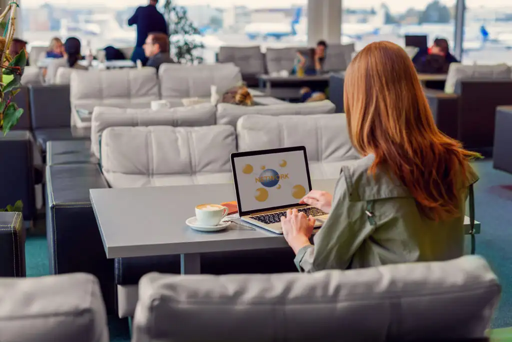 Woman connecting to airport wifi in an airport lounge
