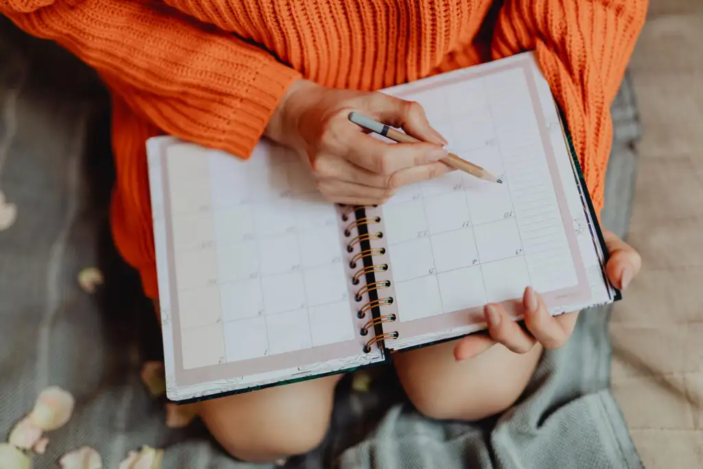 Woman writing in planner