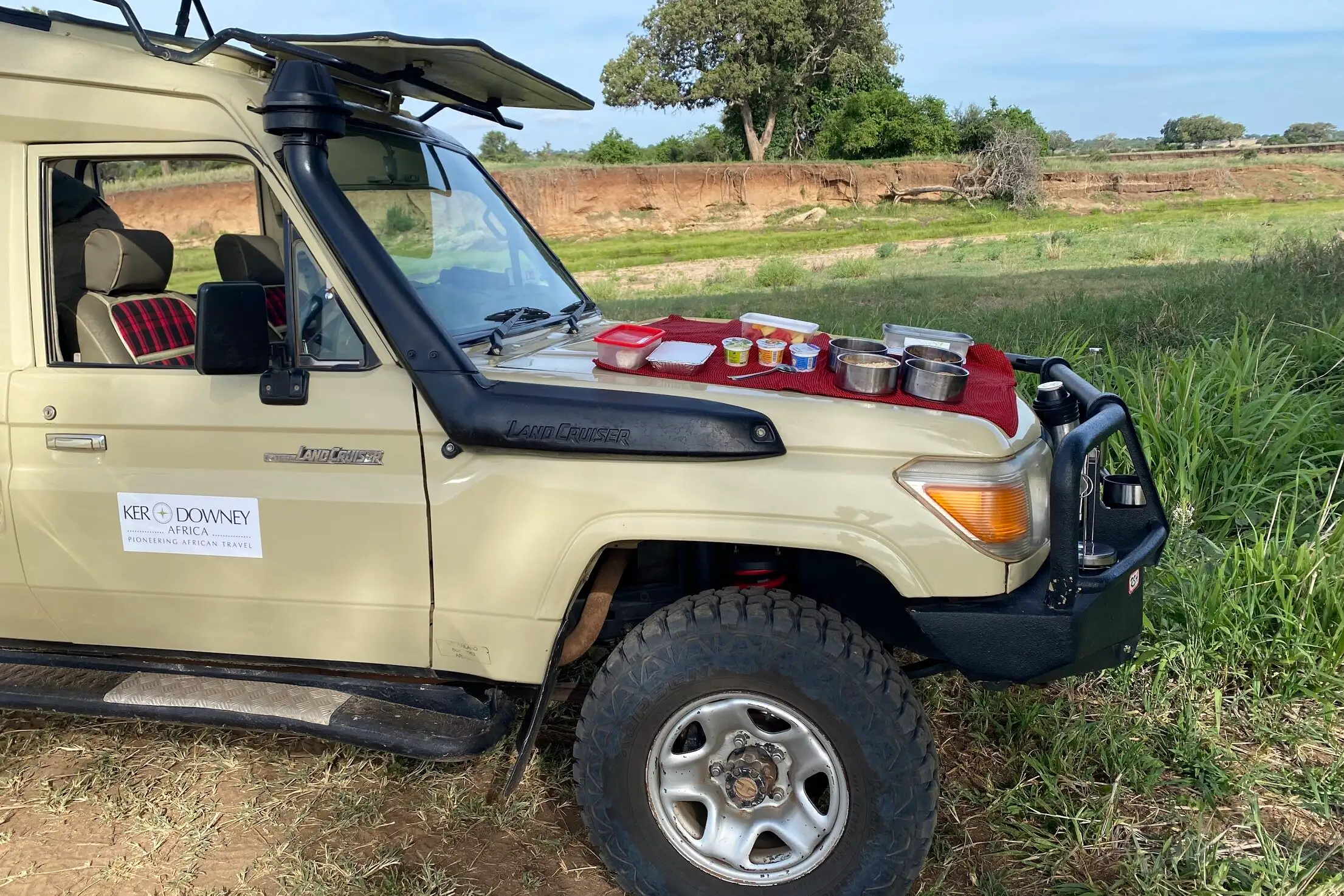 Ker & Downey Africa safari vehicle with afternoon meal laid out on hood