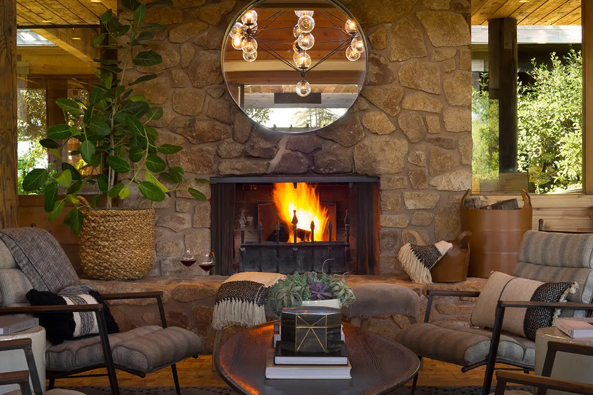 Common area with lit fireplace at Alila Ventana Big Sur
