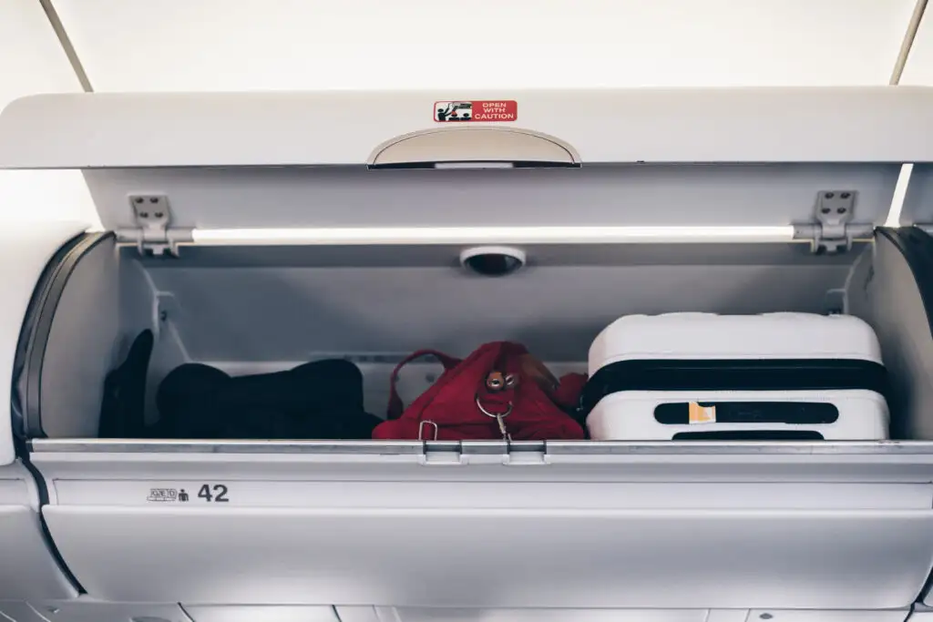 Luggage in an overhead bin on an airplane