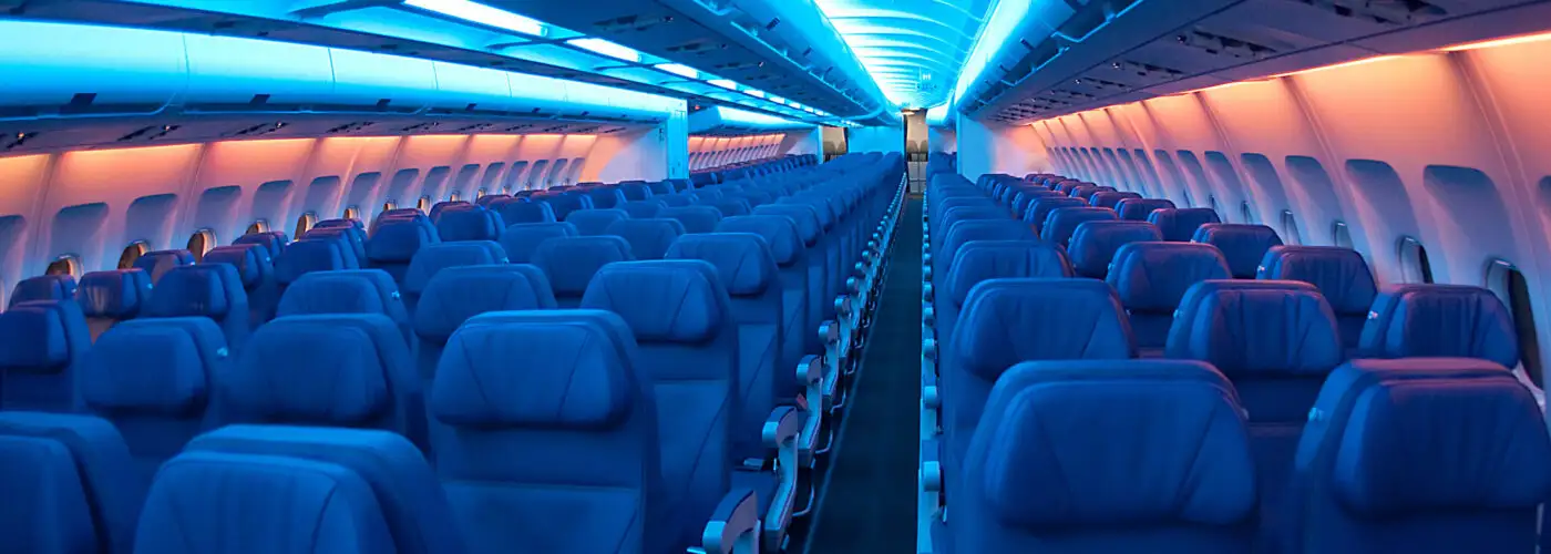 Empty airplane cabin with lights dimmed