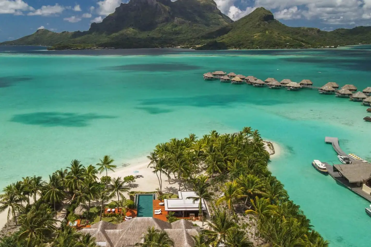 Aerial view of overwater bungalows and main property at the Four Seasons Resort Bora Bora