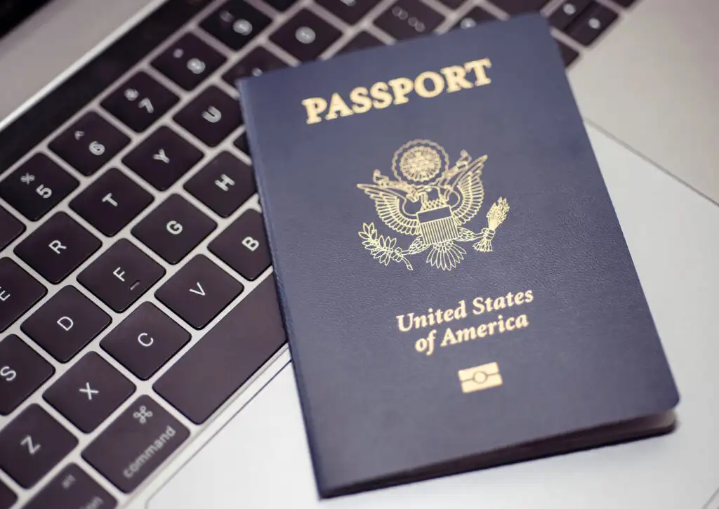 United States passport resting on top of a keyboard