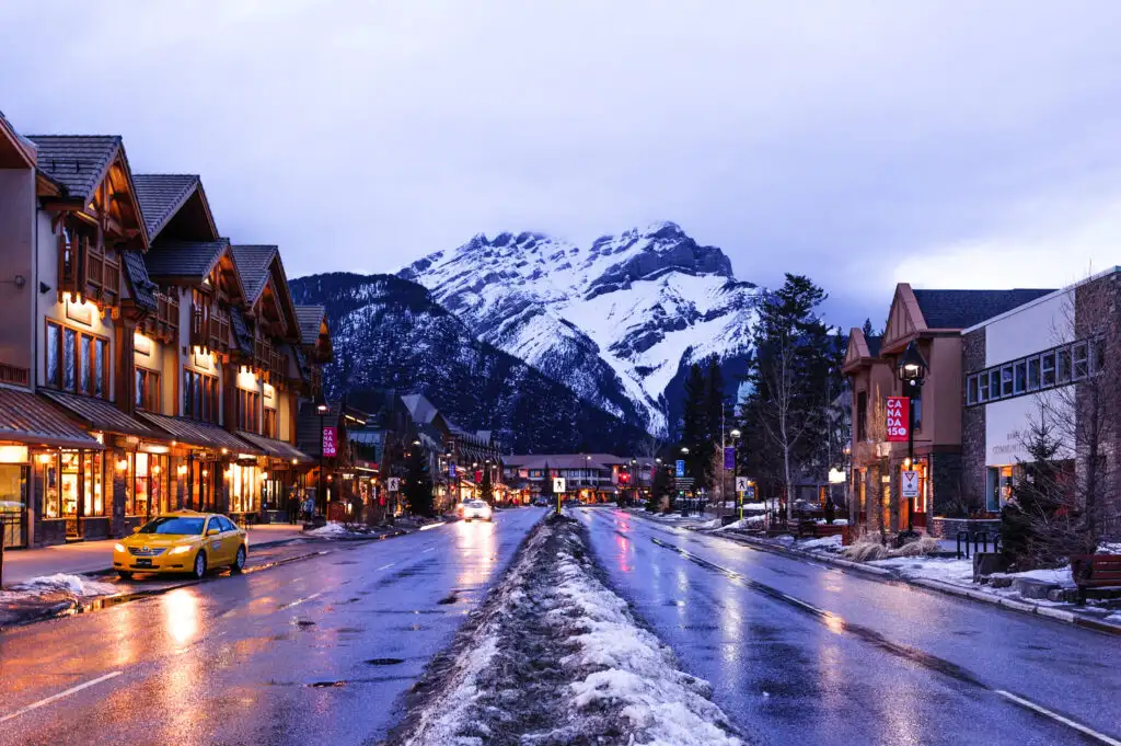 Town of Banff with mountains in background in Alberta, Canada at dusk