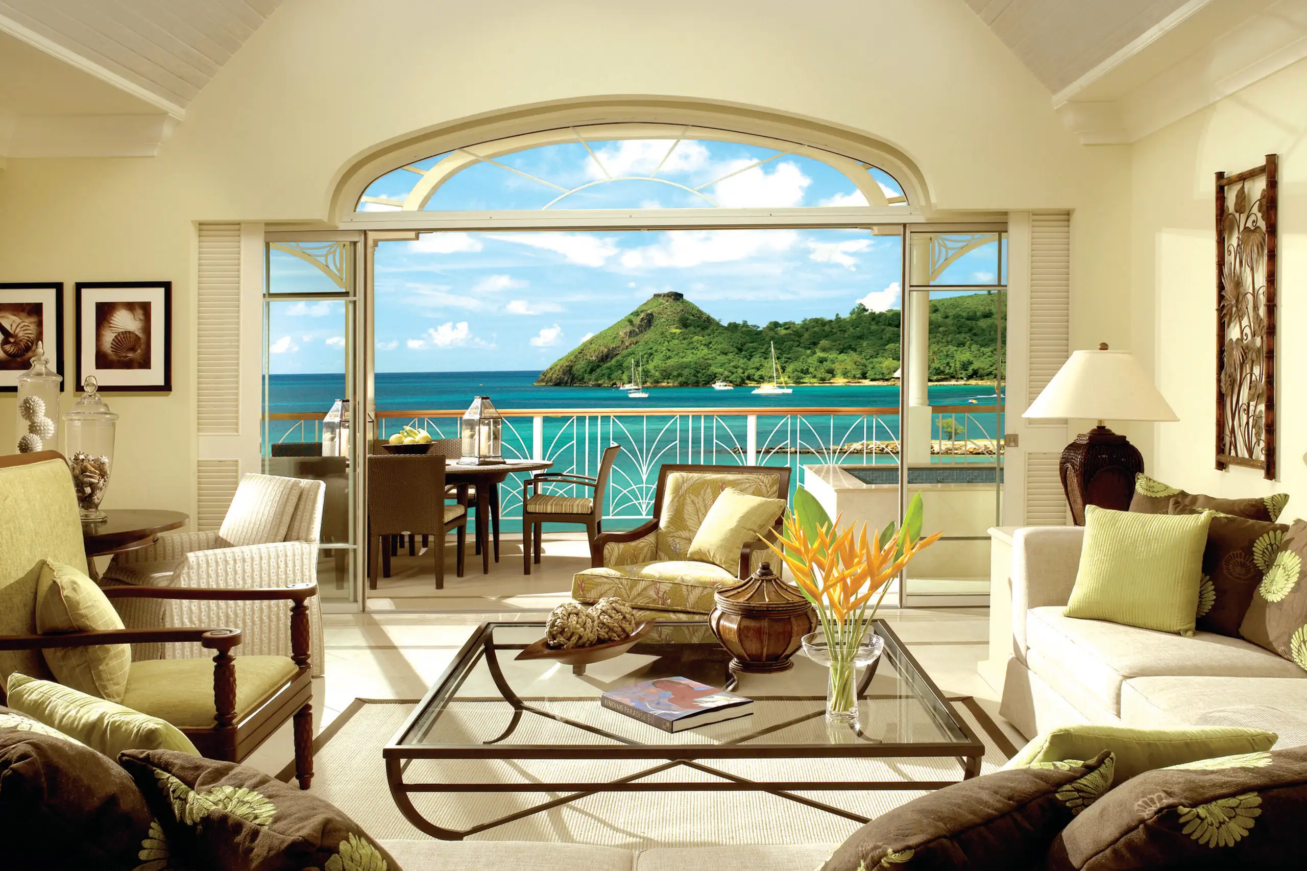 Living area of a suite at The Landings Saint Lucia, with large balcony doors open to the ocean view