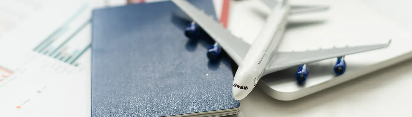 Close up concept of toy plane on a pile of passports and boarding passes
