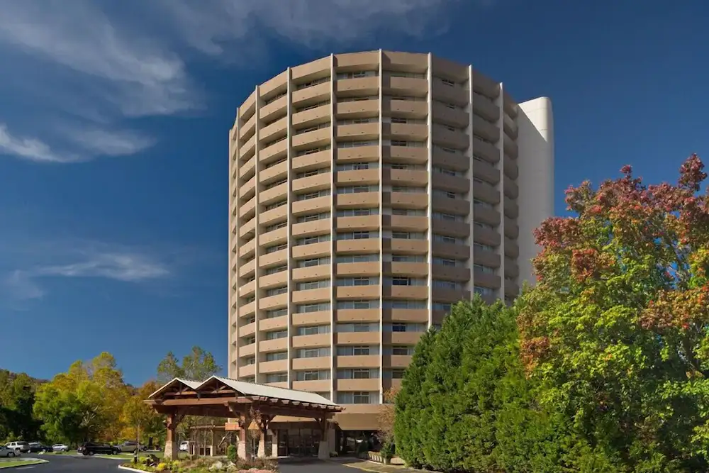 The exterior of The Park Vista DoubleTree with fall foliage. 