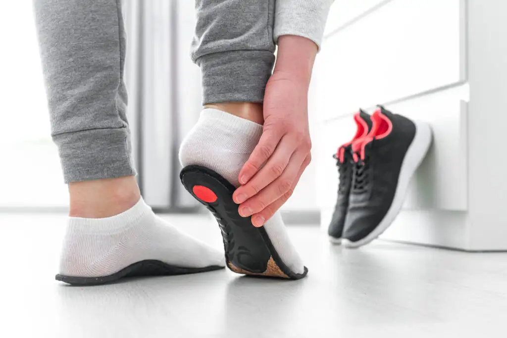 Close up of person testing out insoles for their running sneakers