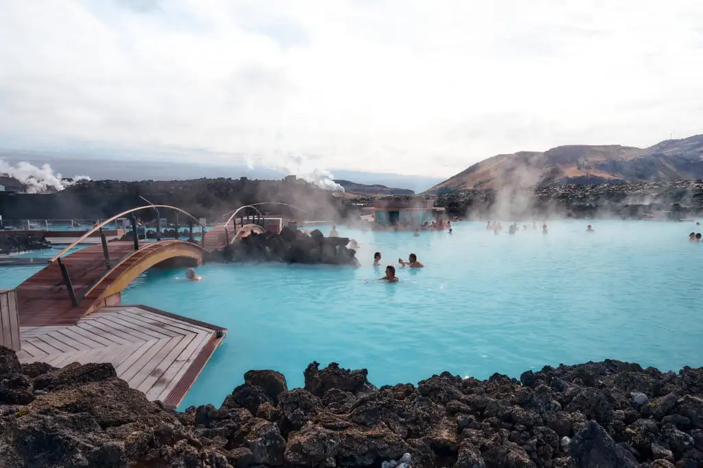 Travelers bathing in the blue lagoon at Reykjavik, Iceland - a unique babymoon destination