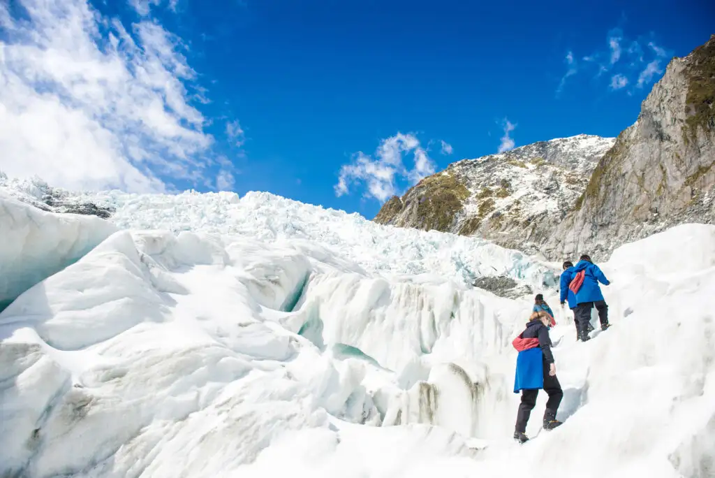 People on guided glacier hike of Franz Josef glacier in New Zealand