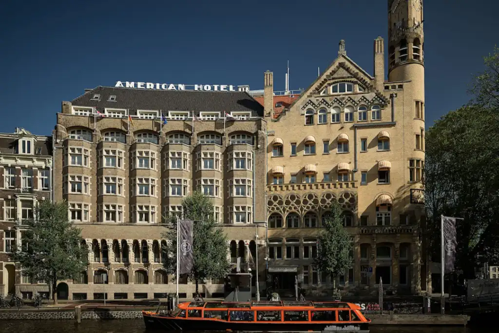 Front exterior of the Hard Rock Hotel Amsterdam American from across the river