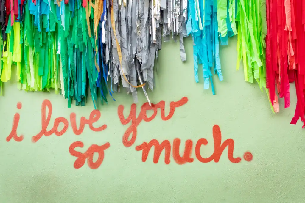 Famous green "I Love You So Much" mural in downtown Austin Texas with colorful confetti