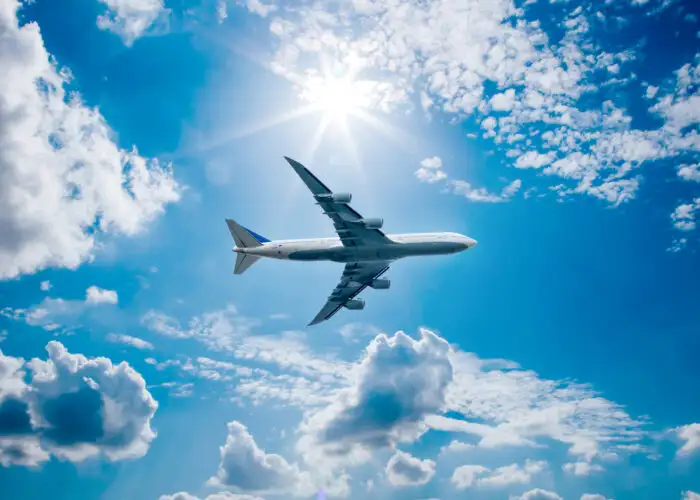 Airplane flying through a blue sky
