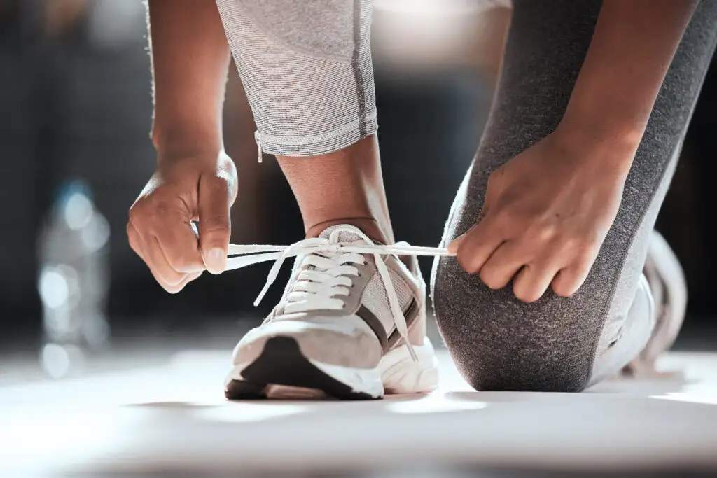 Close up of person tying workout sneakers