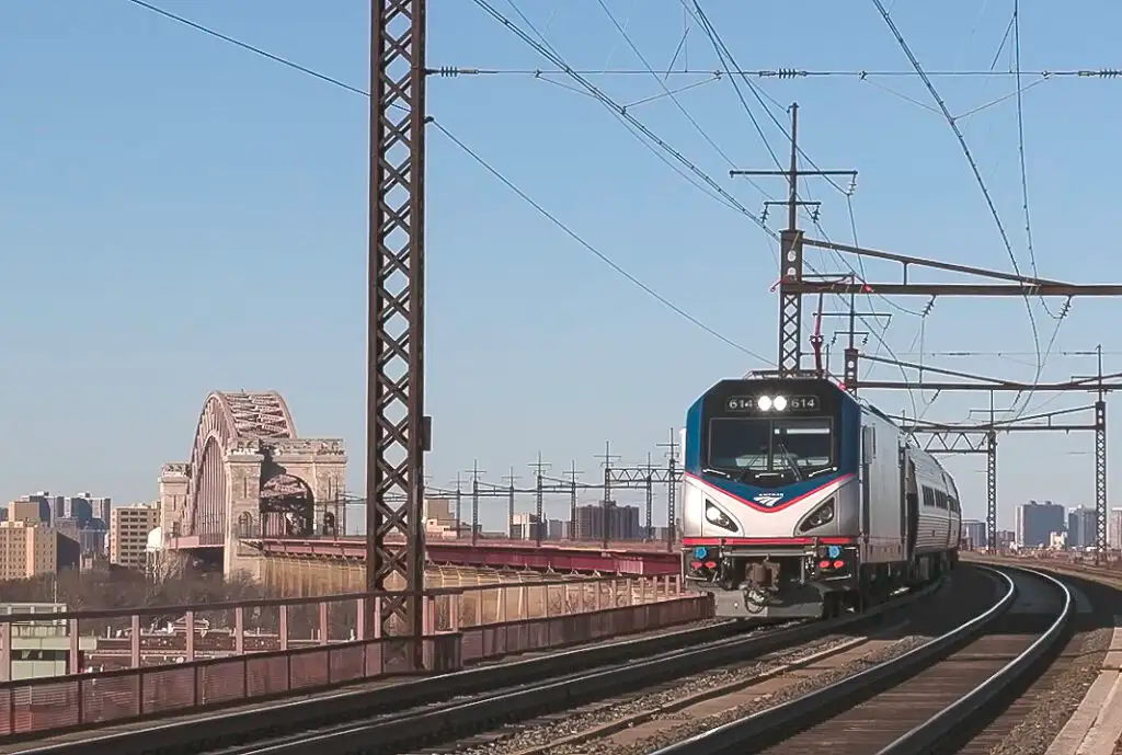 Amtrak train crossing a bridge on the Hell Gate Line in New York