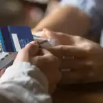 Close up of person scanning a blue credit card