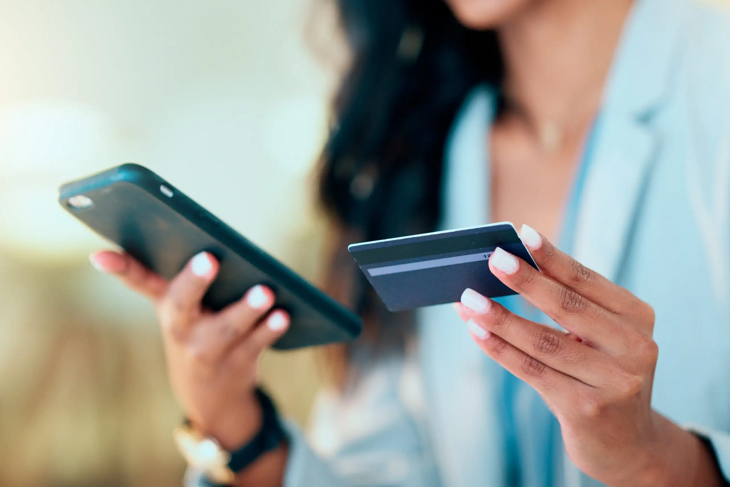 Close up of woman making a credit card purchase on her phone