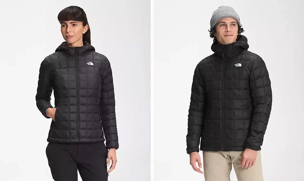 Two models wearing the The North Face ThermoBall Eco Hoodie 2.0 in men's and women's sizes