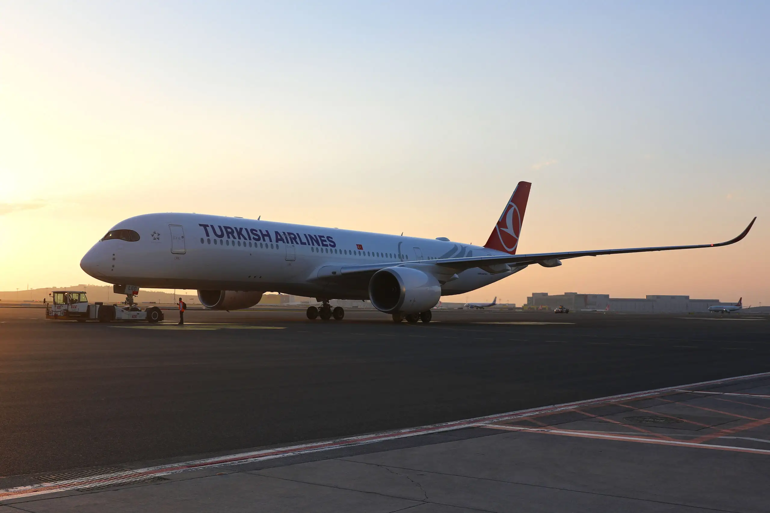 Turkish Airlines aircraft on the runway at dusk