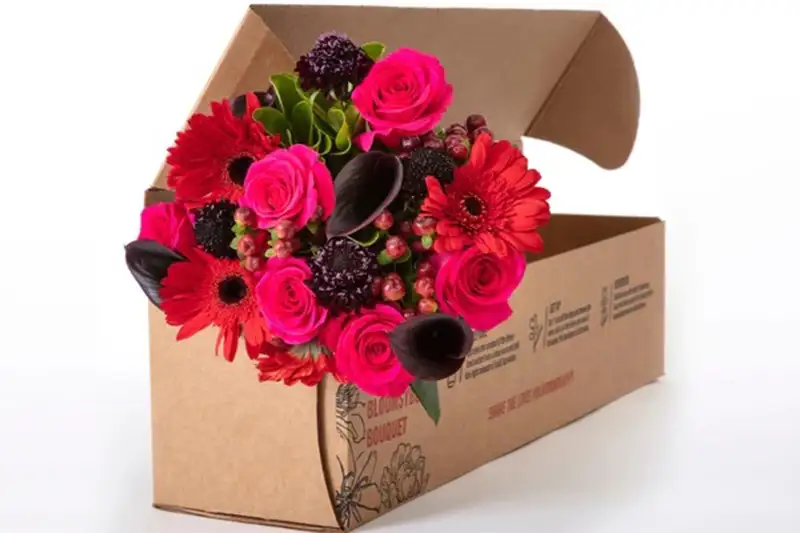 Bouquet of red and purple flowers delivered in a BloomsyBox subscription box